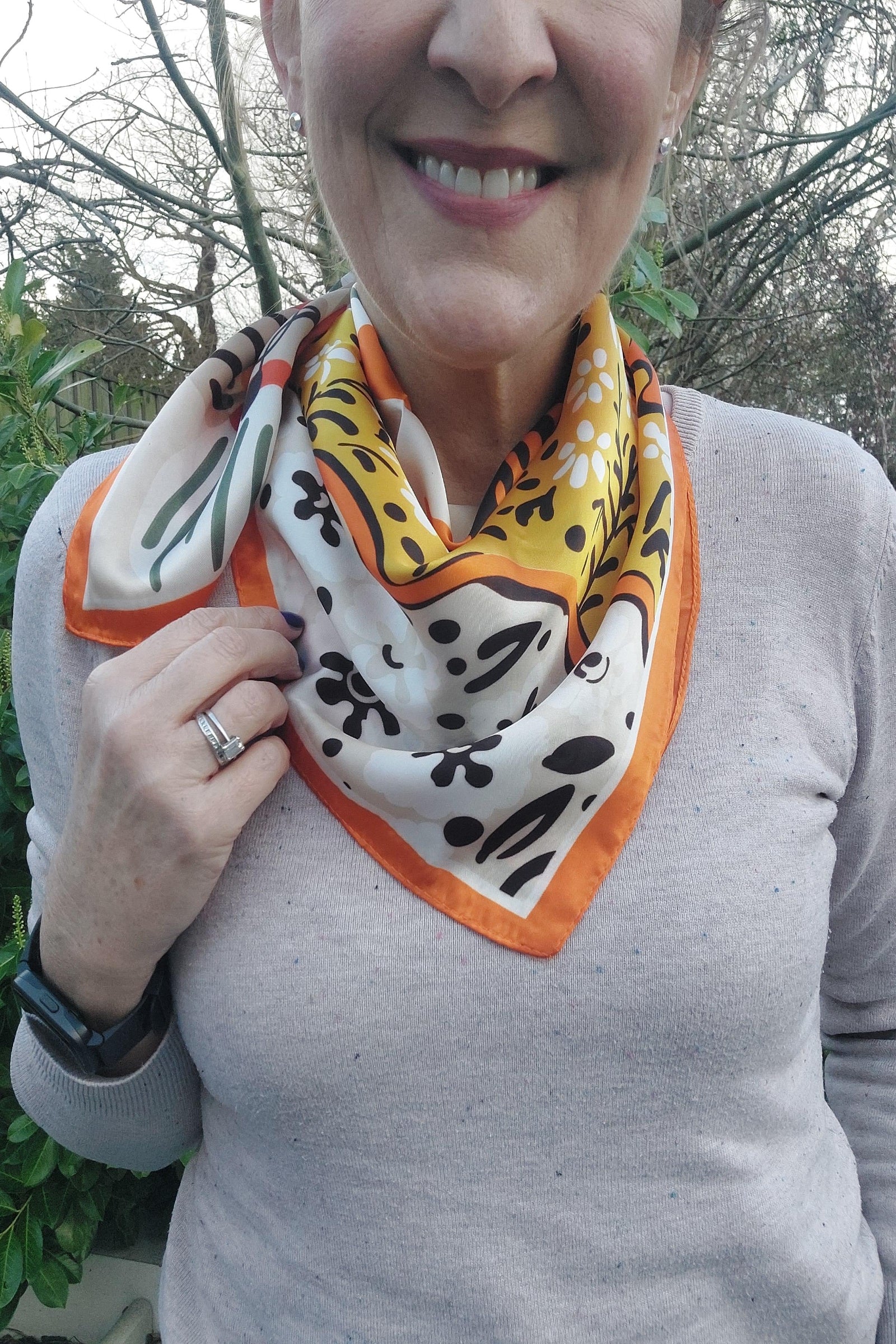 Person wearing a colorful patterned scarf outdoors