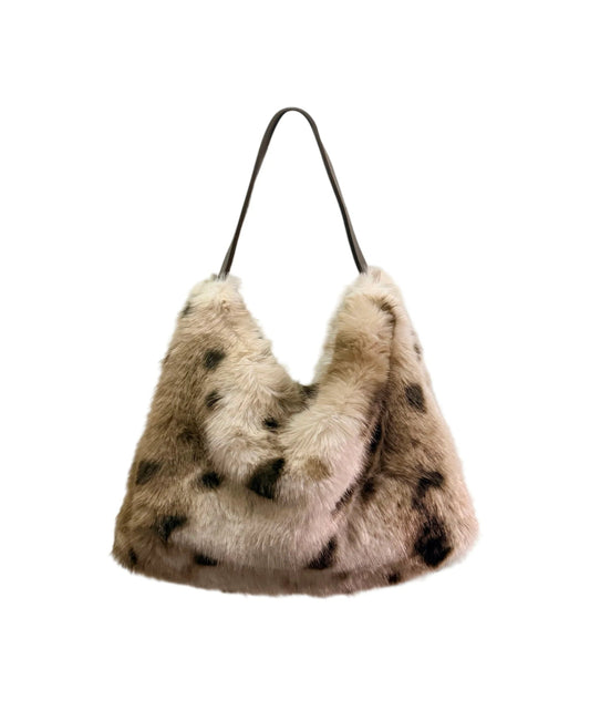 Cream faux fur tote bag with deer print, top handles and magnetic ring fastening.